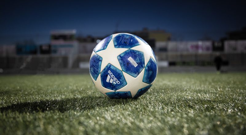 white blue soccer ball on green grass field during daytime